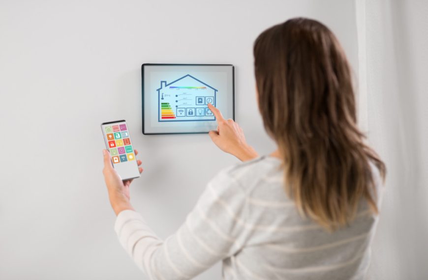Woman using a tablet to control energy usage in a smart home.