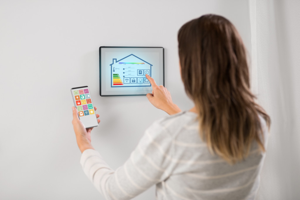 Woman using a tablet to control energy usage in a smart home.