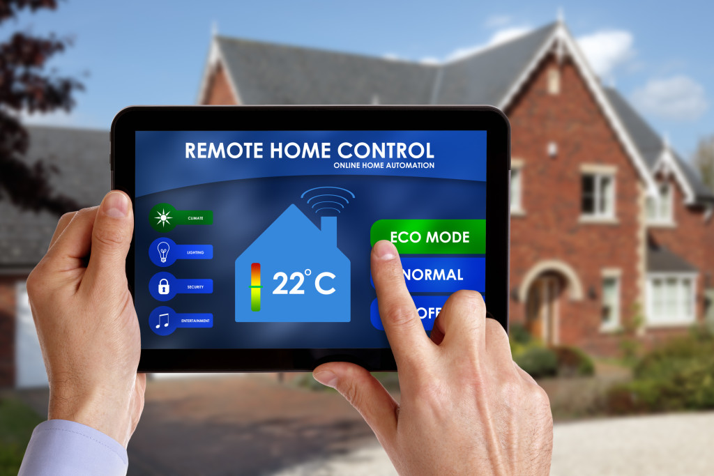 Home owner controlling the home automation system using a tablet.