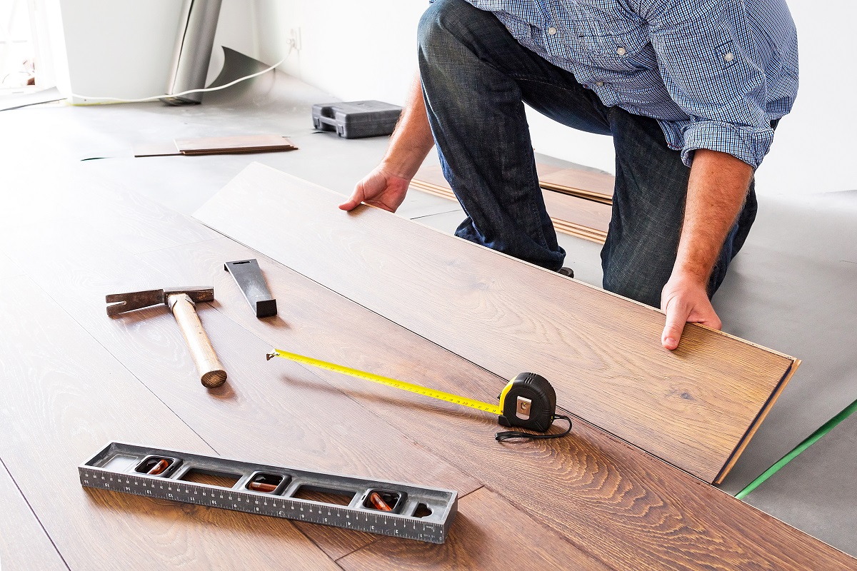 A man installing hardwood floors